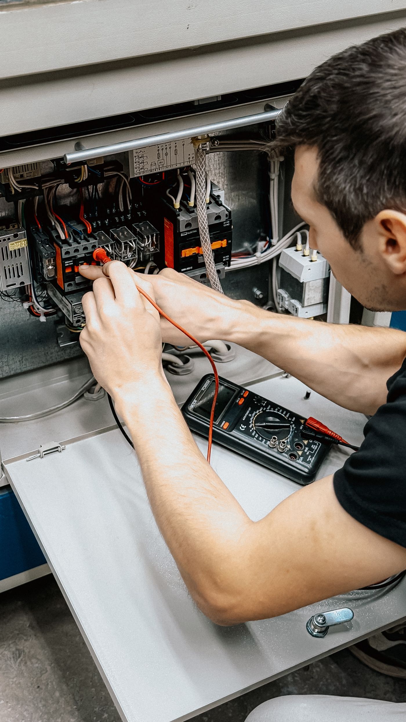 An electrician testing a panel on the job